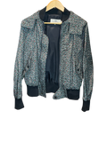 Modify Thrift vintage Coach hooded bomber jacket with teal, pink, and olive ditsy floral print and dark ribbed trim.