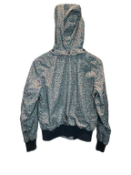 Modify Thrift vintage Coach hooded bomber jacket with a teal, pink, and olive micro-floral print on a dark background.