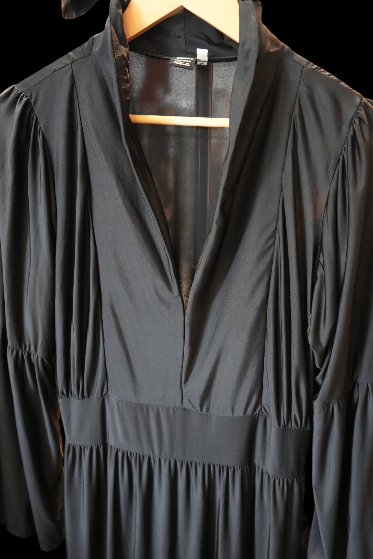 Modify Thrift black maxi dress with a high stand collar, deep plunging V-neck, and gathered bodice details.