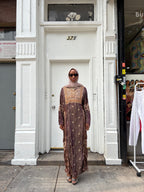 Modify Thrift chocolate brown silk-satin maxi dress with gold vine embroidery worn by a woman in a hijab and glasses.
