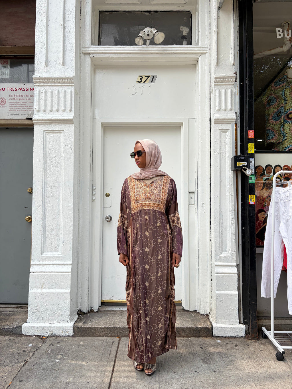Modify Thrift chocolate brown silk-satin maxi dress with antique gold vine embroidery worn by a woman in a hijab.