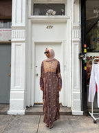 Modify Thrift chocolate brown silk-satin maxi dress with antique gold vine embroidery worn by a woman in a hijab.