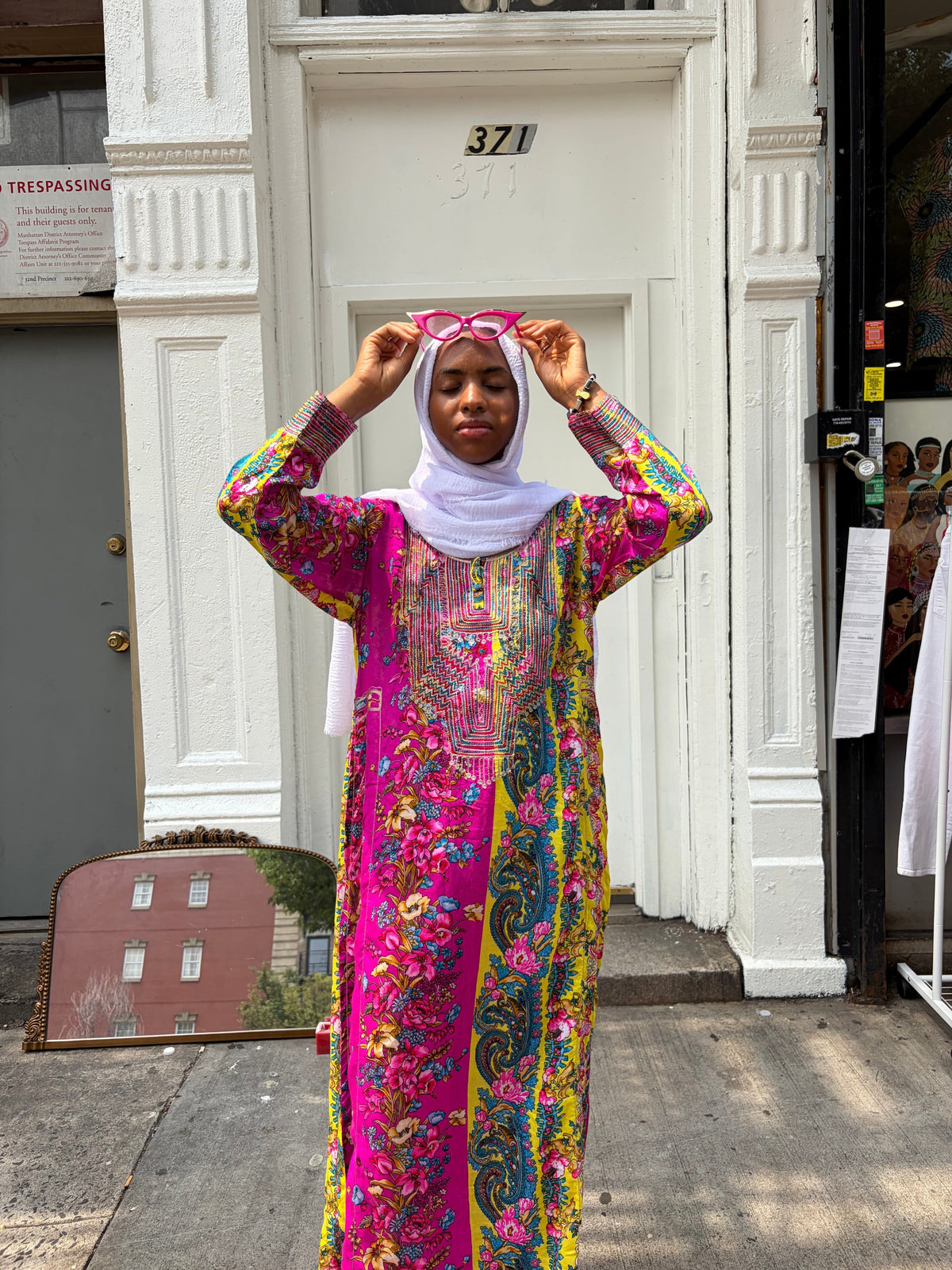 Modify Thrift vibrant floral and paisley maxi kaftan dress with embroidered bib panel worn by a model in a headscarf.