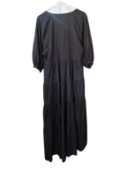 Modify Thrift Zara black midi dress with three-quarter puff sleeves and a tiered skirt hanging in a retail shop