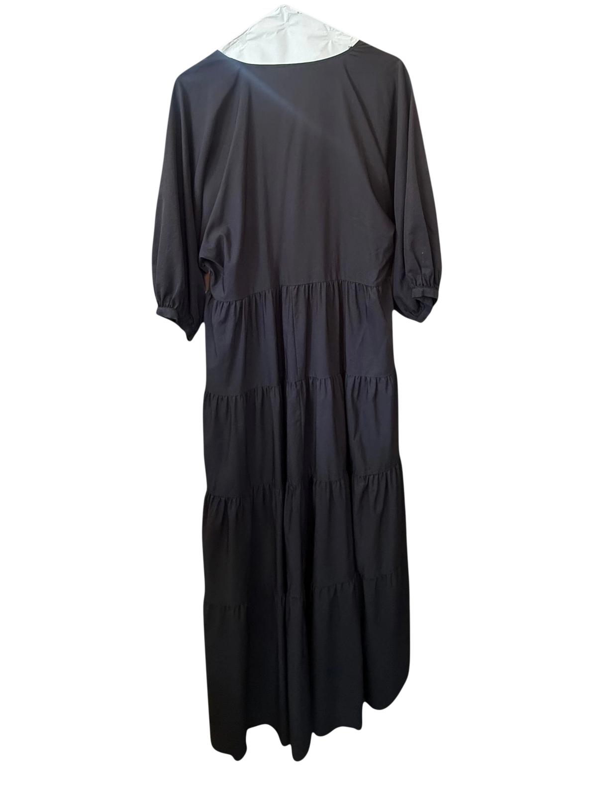 Modify Thrift Zara black midi dress with three-quarter puff sleeves and a tiered skirt hanging in a retail shop